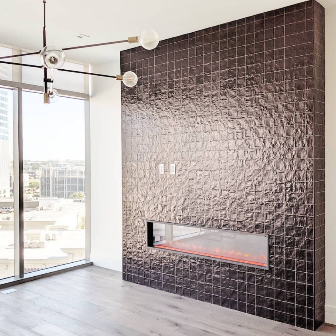 A modern fireplace with Montauk Jet 4x4 Ceramic Wall Tile
