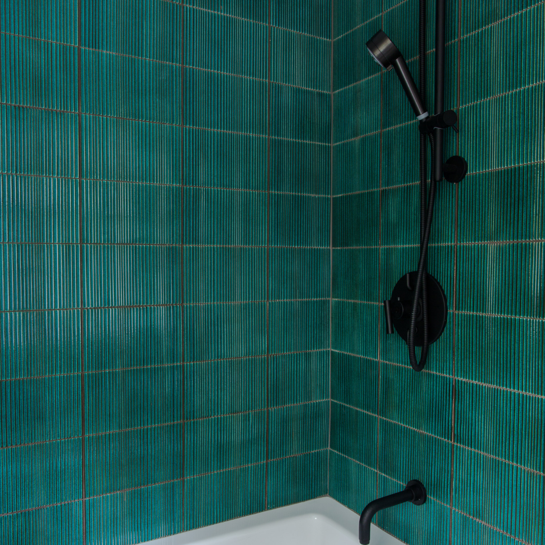 Green tiles in shower with matte features