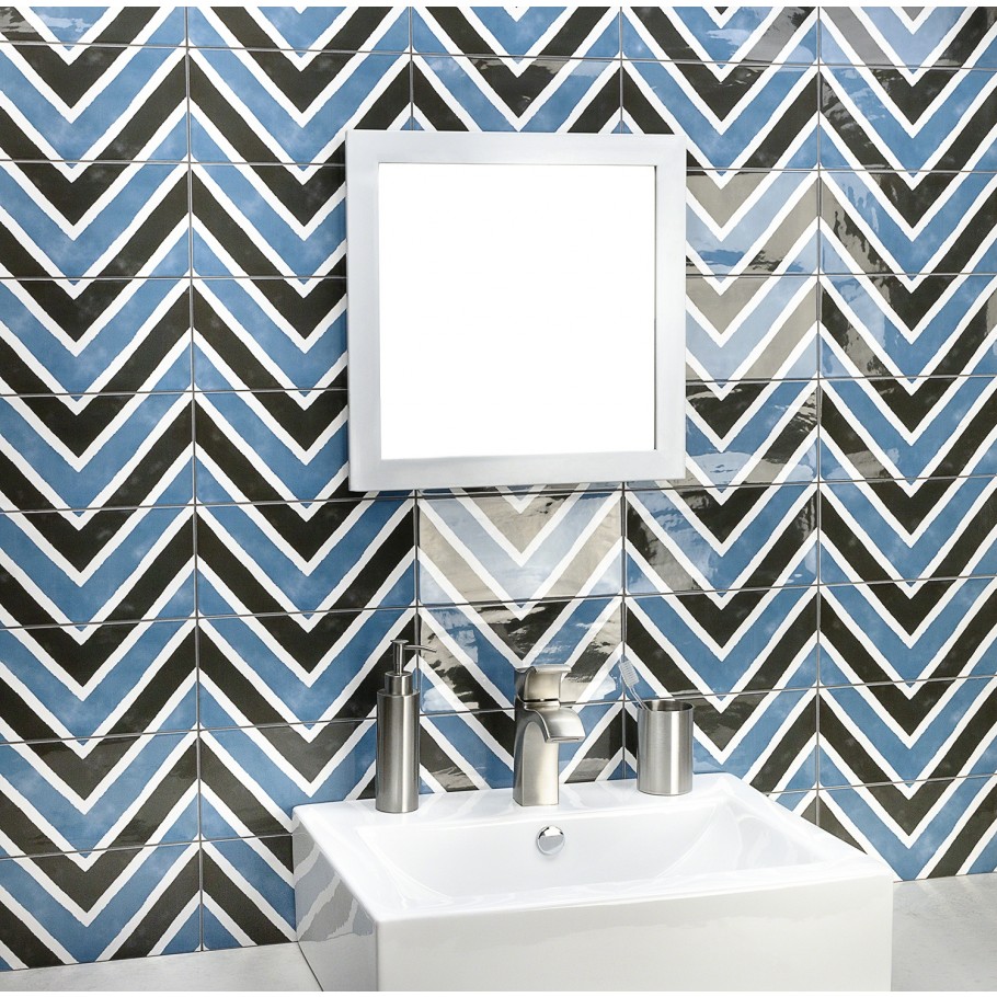 A bold blue and black chevron tile pattern on a bathroom wall 