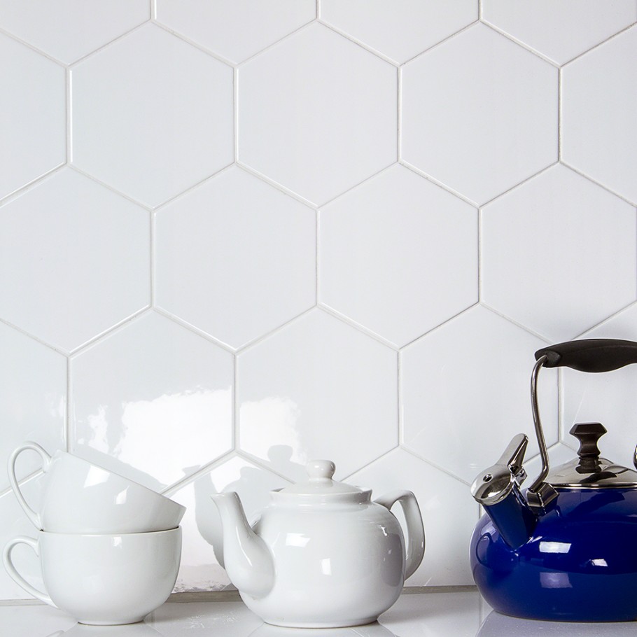 Shiny, polished white hexagon tile on kitchen wall with teapot and cups 