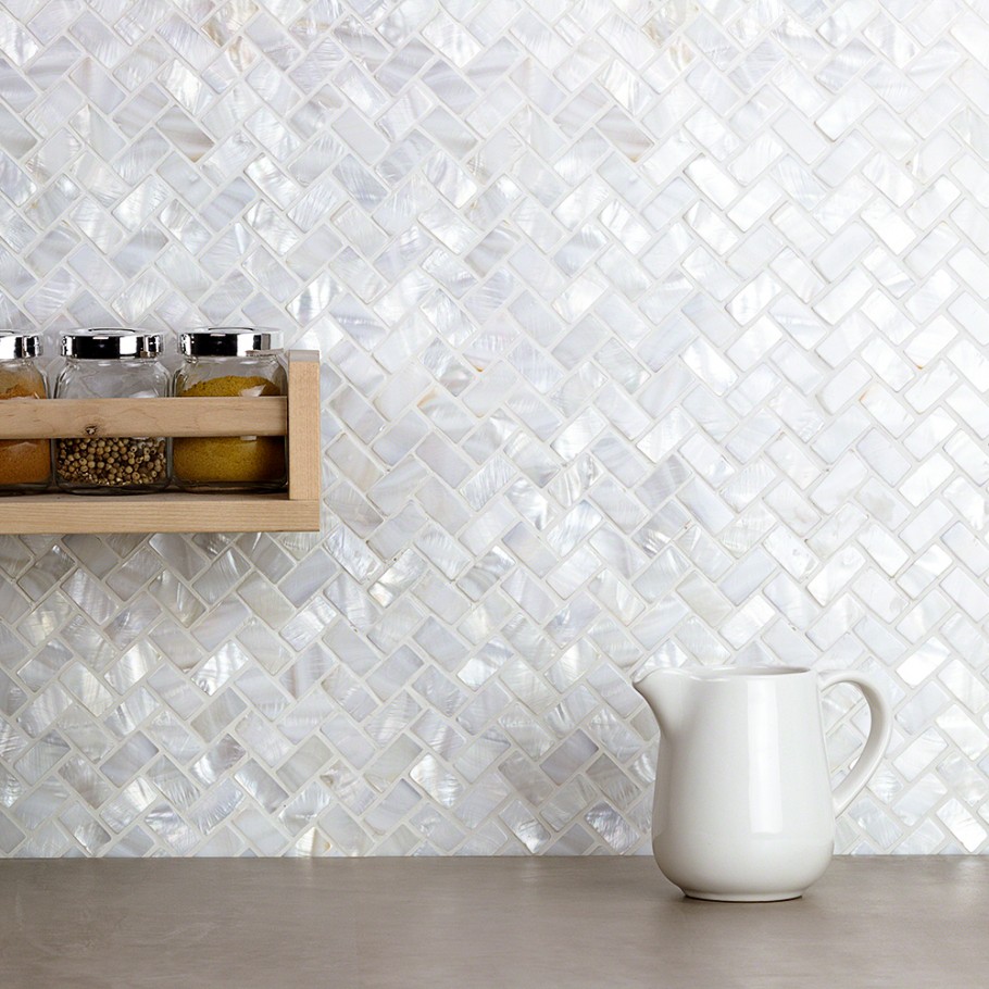 Shiny, pearl wall tile in a herringbone pattern on kitchen wall 
