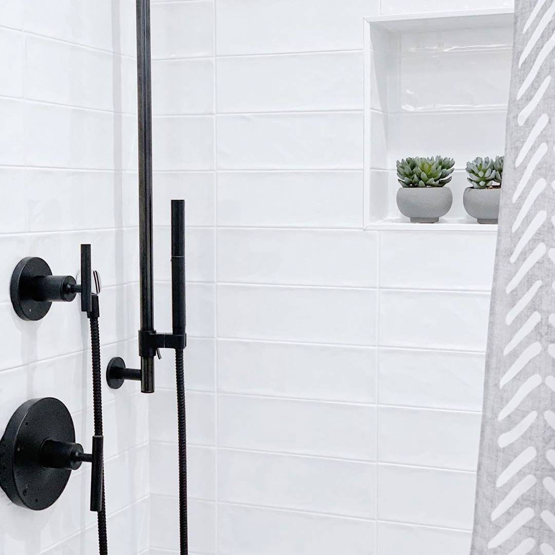 Modern white shower tile with matte shower fixtures Design By Rappaport Homes 