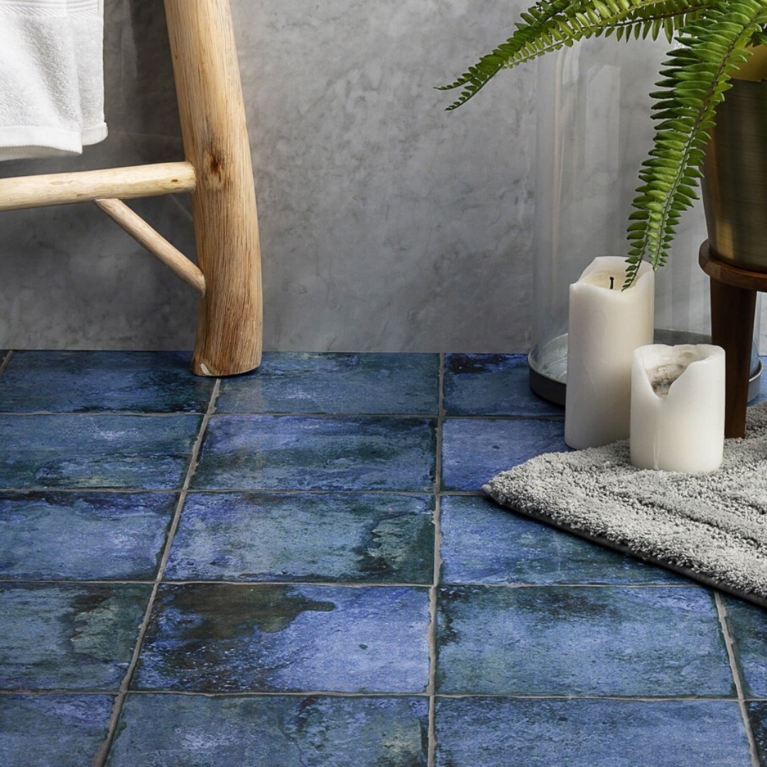 An earthy ombre metallic porcelain floor tile. Plants. Rug.