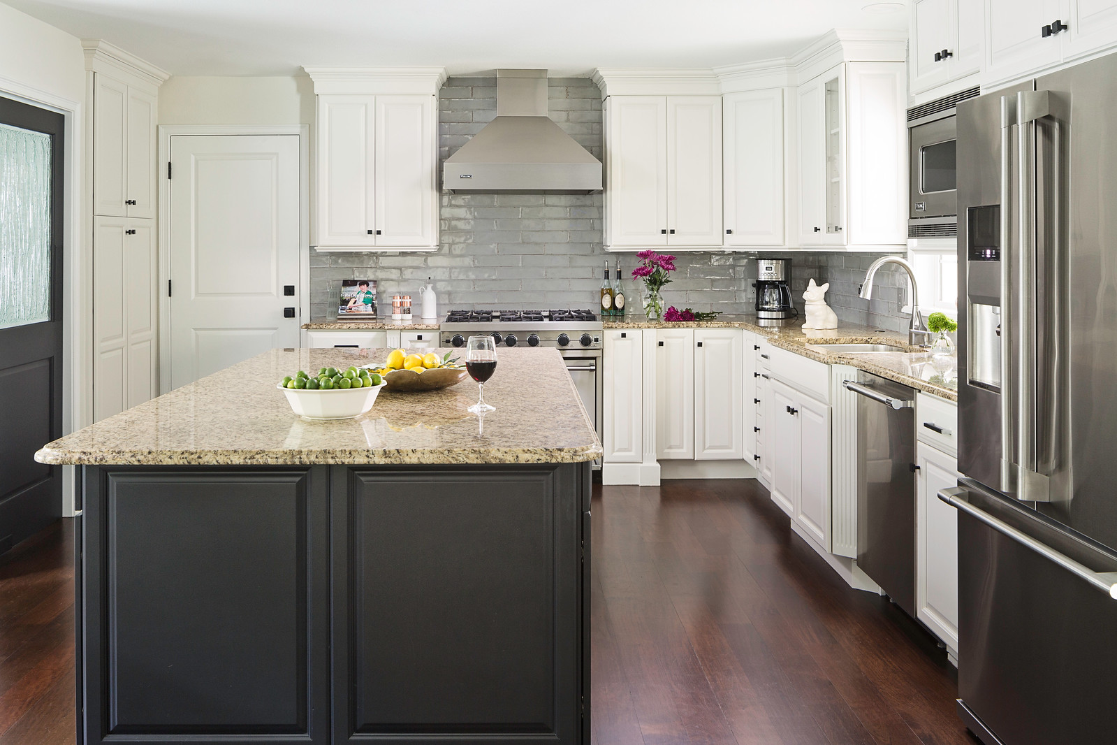 An image showing subway tiles in the kitchen as stove top backsplash as well as wall tiles above the counter tops 