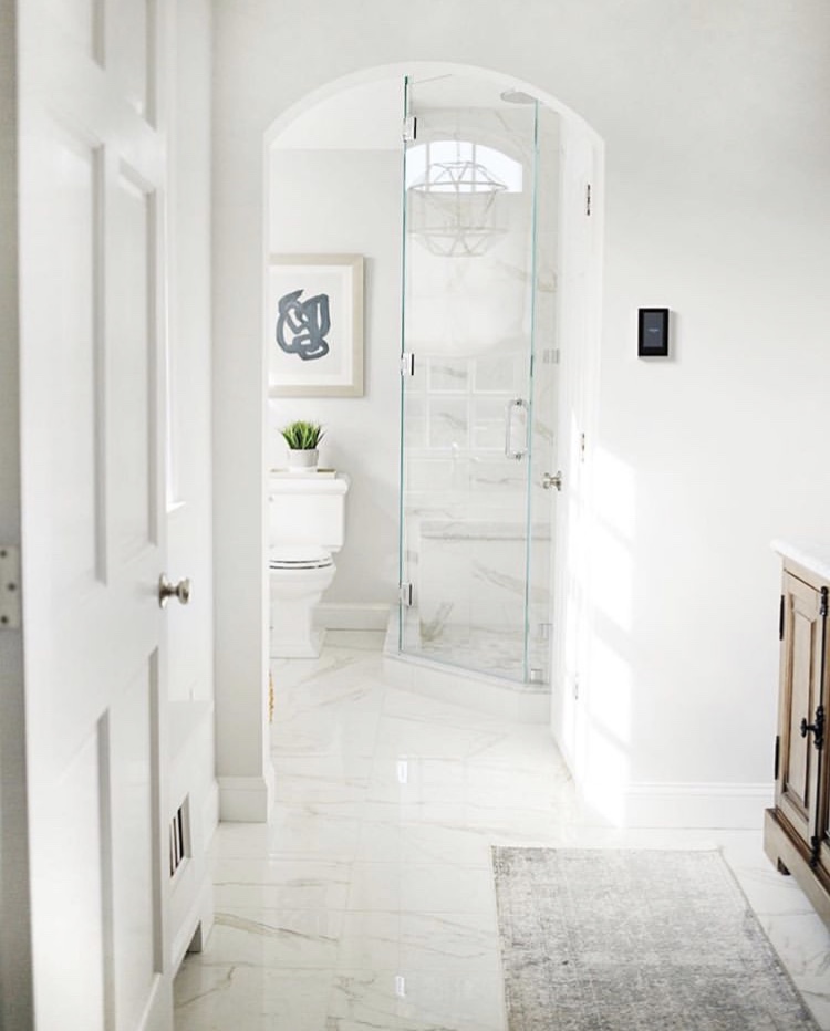 Belvedere Bianco 30x30 Marble Look Porcelain Tile shown n the floor and walls of a modern bathrooom