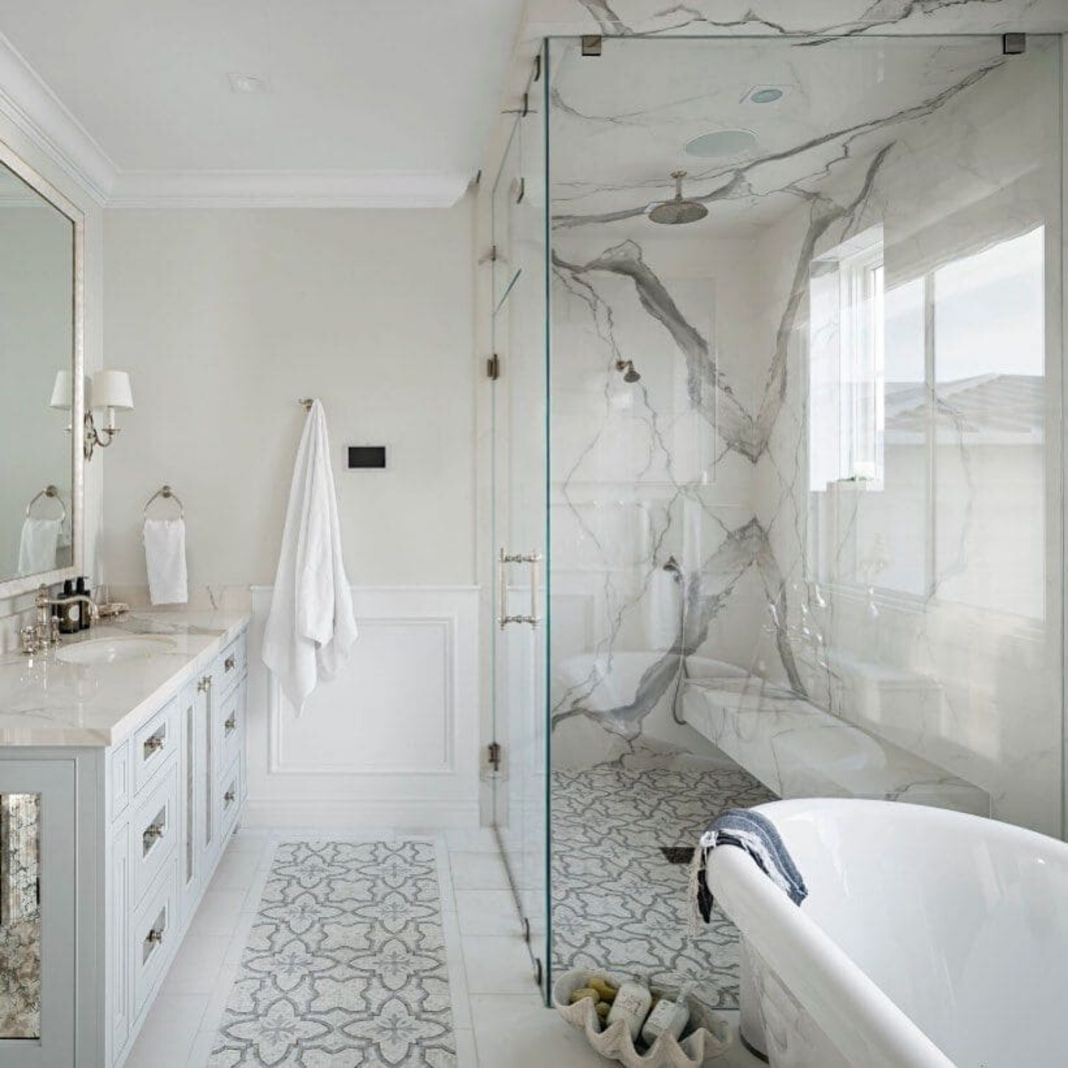 Primrose Bianco Grigio Marble Polished Mosaic Tile shown in the bathroom used on the floor for a luxe aesthetic 